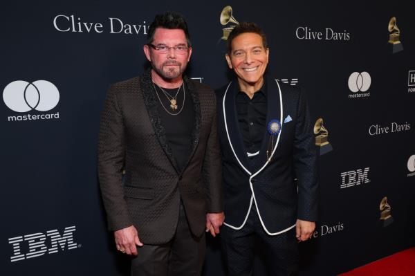 Terrence Flannery and Michael Feinstein at the 66th GRAMMY Awards Pre-Gala event, standing together in front of a black wall.