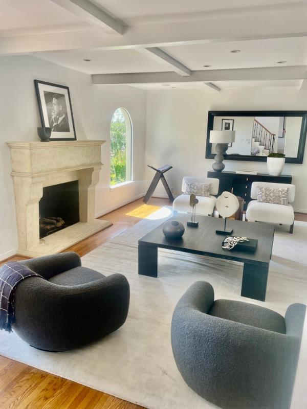 A cozy, charming living room featuring a fireplace and chairs in a 3,078 square foot property at 1348 Miller Dr.