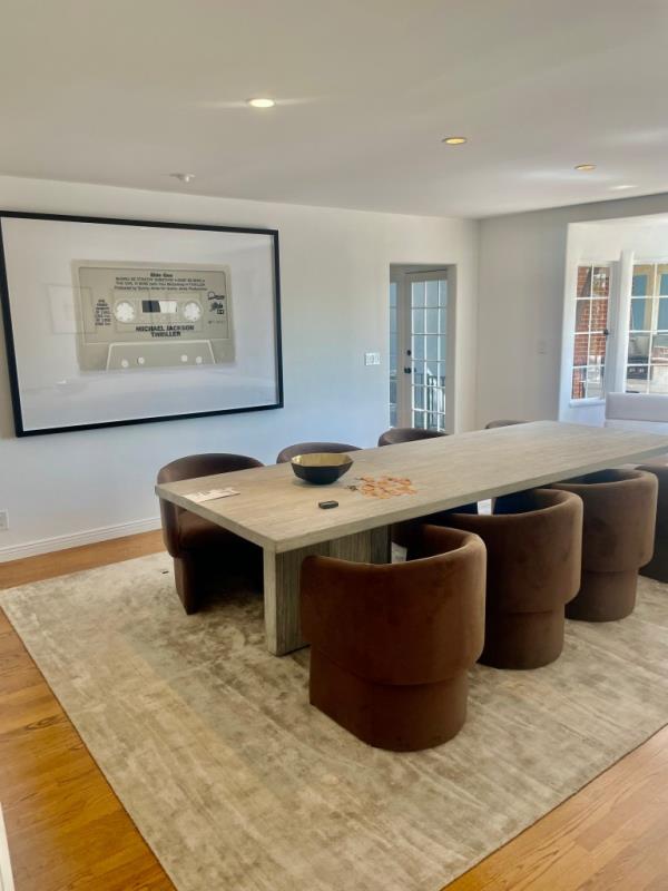 A formal dining area with a table and chairs adjacent to the chef's kitchen