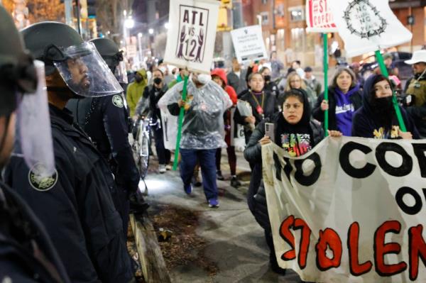 Demonstrators march near Atlanta police during a protest over plans to build a new police training center, Thursday, March 9, 2023, in Atlanta.
