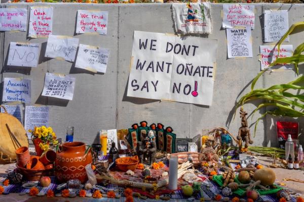 A mural is seen during a protest against the reinstallation of a 16th-century New Mexico conquistador statue at the Rio Arriba County building on 28 September 2023 in Espanola, New Mexico (Getty Images)